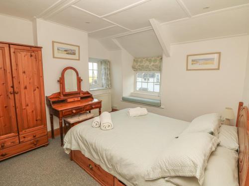 ボスキャッスルにあるFuchsia Cottageのベッドルーム1室(ベッド1台、デスク、ピアノ付)