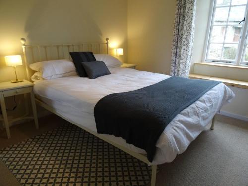 a bedroom with a large bed with two pillows on it at Kingbarth in Lerryn