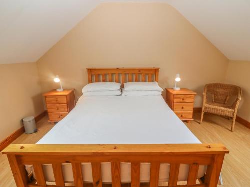 a bedroom with a large bed with two night stands at Cahirkeen Cottage in Eyeries