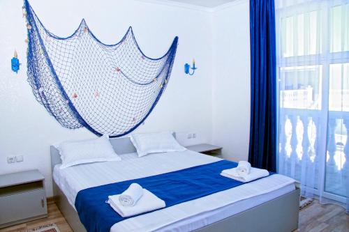 a bedroom with a net hanging above a bed at Del Mare семейный корпус in Kapchagay