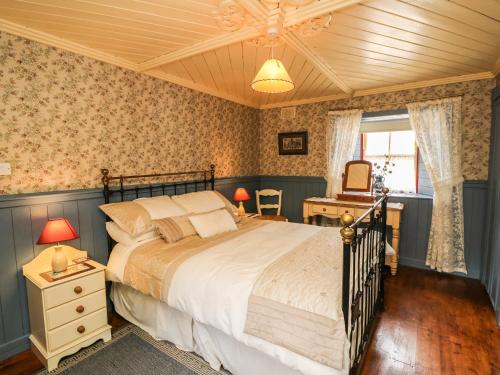 a bedroom with a large bed and a wooden ceiling at O'Neill's in Tipperary