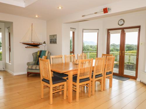 a dining room with a wooden table and chairs at 1 Ard Carraig in Portsalon