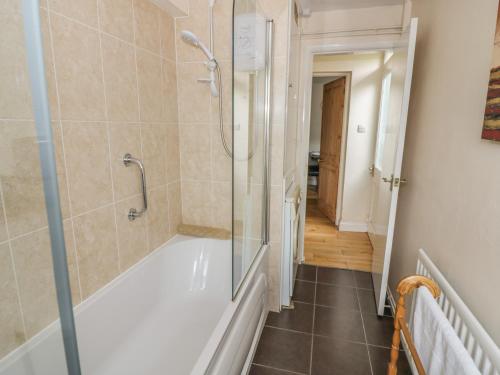 a bathroom with a shower and a bath tub at Pinecote in Stratford-upon-Avon