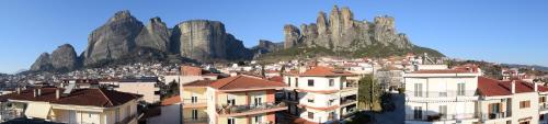 a group of buildings in front of a mountain at Meteora 360 Apartment by Meteora Residencies in Kalabaka