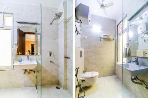 a bathroom with two sinks and a glass shower at Royal Comfort Castle in New Delhi