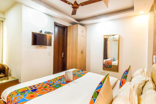 a bedroom with a bed and a television in a room at Royal Comfort Castle in New Delhi
