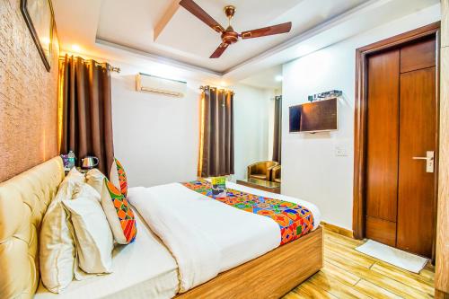 a bedroom with a bed and a brown door at Royal Comfort Castle in New Delhi