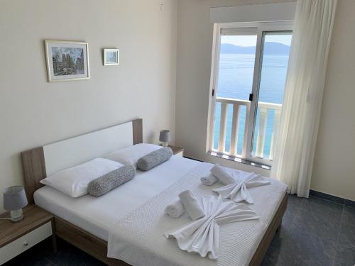a bedroom with a bed with a view of the ocean at Villa Orca in Podaca