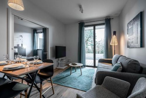 a living room with a couch and a table at La Grange des Pères in Pringy