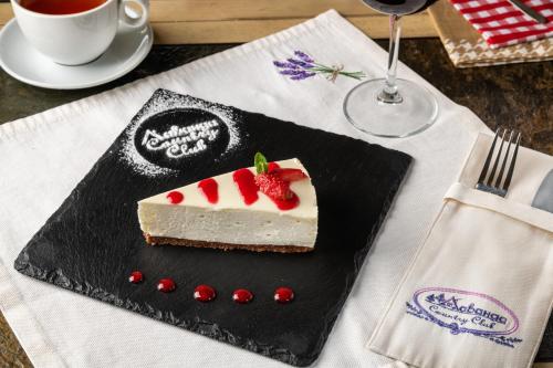 a piece of cake on a black plate on a table at LAVANDA country club in Tatariv