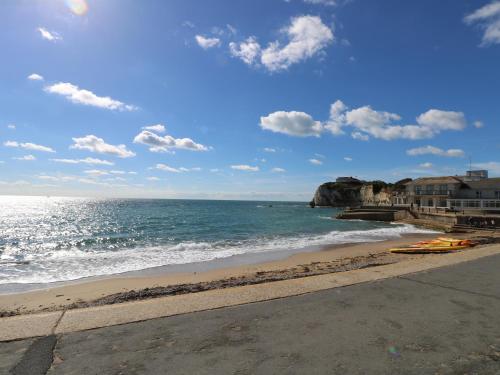 a beach with a yellow kayak on the shore at Serendipity in Freshwater