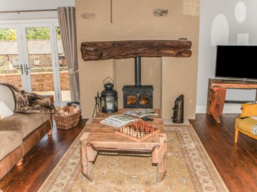 a living room with a wood stove and a couch at The Granary in Durham