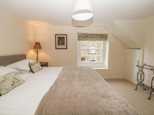 a bedroom with a large bed and a window at Stanfree House in Matlock