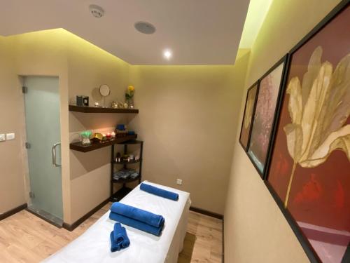 a room with a bed with blue pillows in it at Naviti Warwick Dammam in Dammam