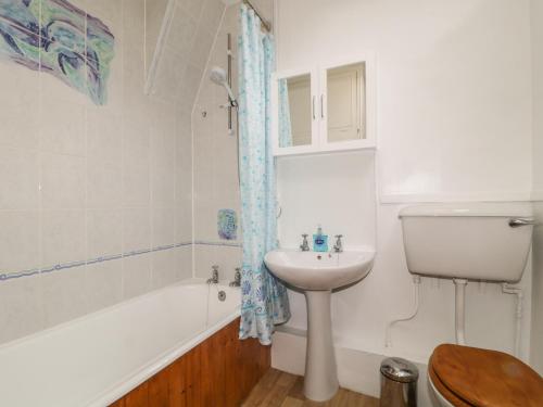 a bathroom with a sink and a toilet and a bath tub at Derwent Edge in Portinscale