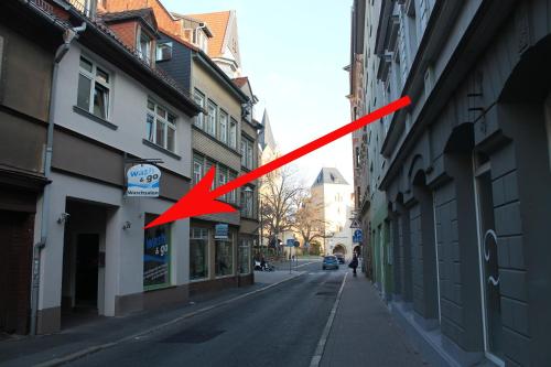 a red arrow is pointing down a city street at Pension Michelangelo in Eisenach
