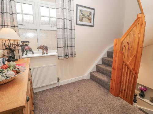a room with stairs and a window and a stair case at River Cottage in Morpeth