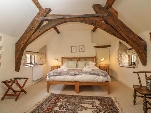 a bedroom with a bed in an attic at Bull Cottage in Burford