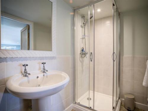 a bathroom with a sink and a shower at The Granary in Bledington