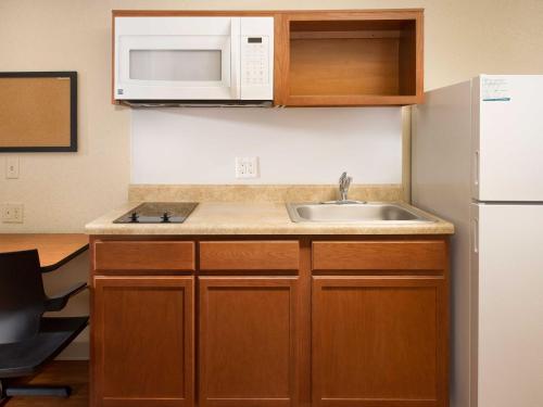 a kitchen with a sink and a microwave at WoodSpring Suites Wilkes-Barre in Wilkes-Barre