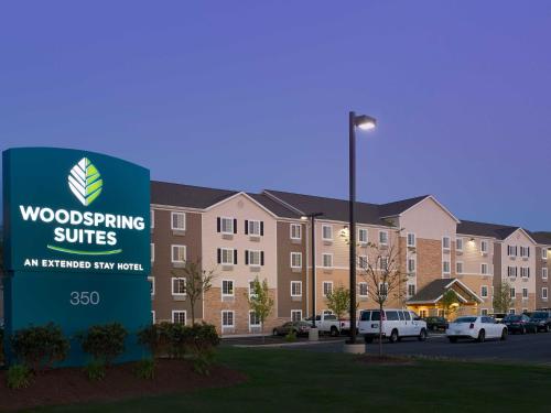 a building with a sign in front of a building at WoodSpring Suites Wilkes-Barre in Wilkes-Barre