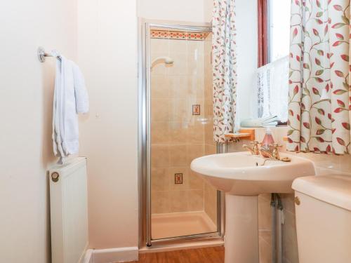 a bathroom with a sink and a shower at Little Waycroft in Dawlish