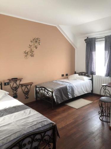 a bedroom with two beds and a window at Four S Palace in Băile Borşa