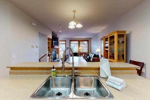 a kitchen with a sink and a counter top at Tree Tops in Big White