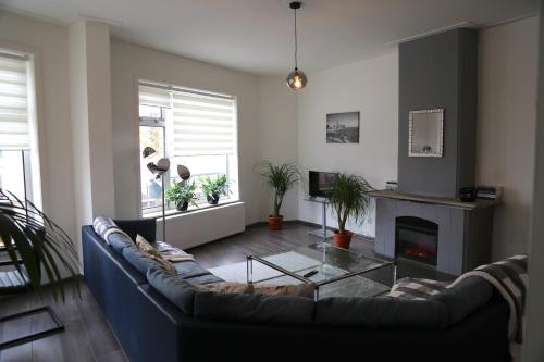 a living room with a couch and a fireplace at Beach Appartement in Vlissingen