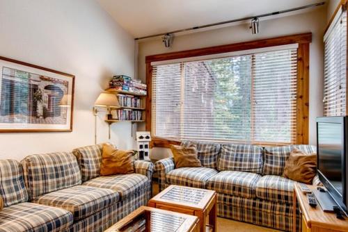 a living room with two couches and a tv at Ski-InandSki-Out Northstar Condo Near Lake Tahoe! in Truckee