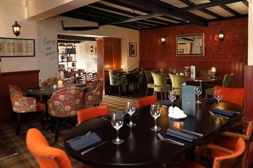 a dining room with tables and chairs in a restaurant at The Rising Sun in Coltishall