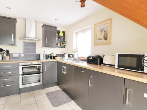 a kitchen with stainless steel cabinets and a microwave at Gerand in Windermere