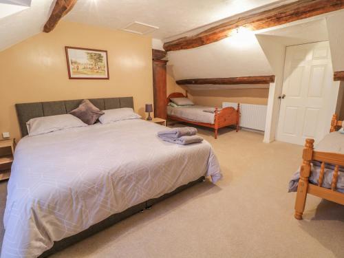 a bedroom with a large bed in a room at Pengwern in Pennant-Melangell