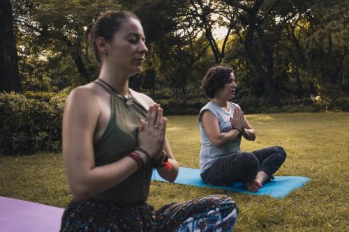 two women sitting on the grass in a park at AmigosIndia in New Delhi