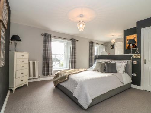 a bedroom with a large bed and a window at Penlaurel in Launceston