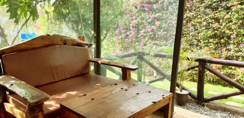 
a wooden bench sitting in front of a window at Fun Retreat Resort, Hotel and Ayurveda Spa in Arusha
