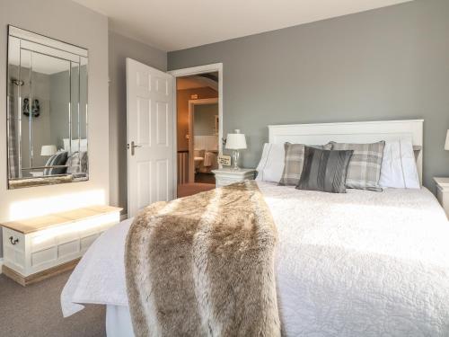 a bedroom with a white bed and a mirror at Penlaurel in Launceston