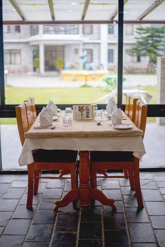 a table with two chairs and a box on it at Gateway Himalaya Resort in Ghanpokhara