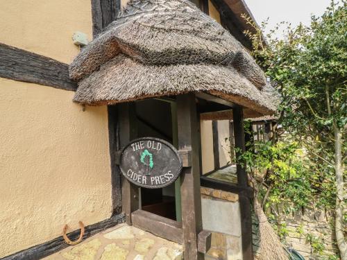 an old cider house with a sign in the door at The Old Cider Press in Broadway