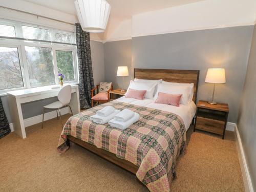a bedroom with a bed with two pillows on it at Coedfryn in Betws-y-coed