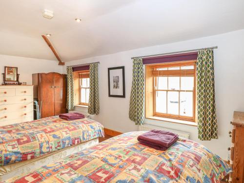 מיטה או מיטות בחדר ב-3 Station Cottages