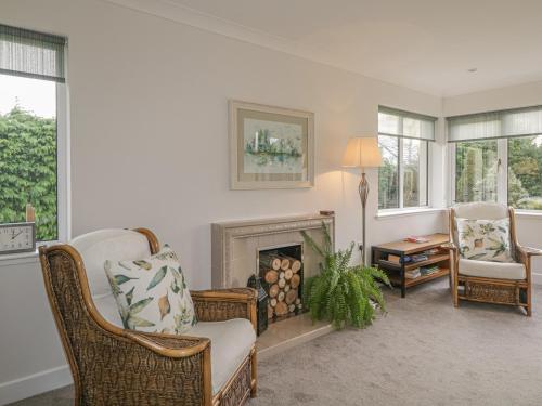 a living room with a chair and a fireplace at Number 11 in Beauly