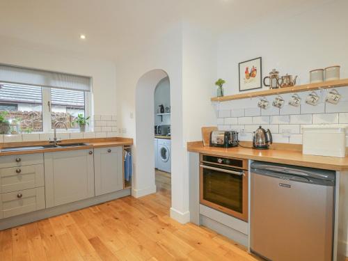 a kitchen with a sink and a stove top oven at Number 11 in Beauly