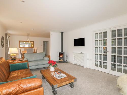 a living room with a couch and a table at Number 11 in Beauly