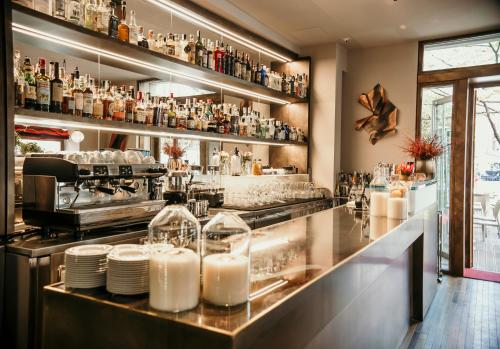 a bar with a counter with plates and glasses at Posta Design Hotel in Como