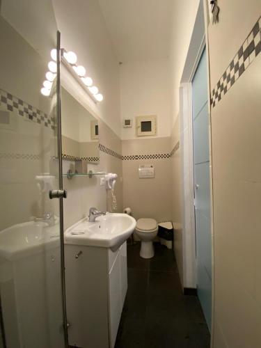 a white bathroom with a sink and a toilet at B&B Mini Hotel Incity-close train station and port- in Salerno