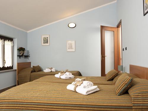 a bedroom with two beds with towels on them at La Locanda del Priore in Vale