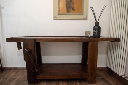 a wooden table in a room with a vase on it at Casa Del Profumo in Piacenza