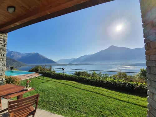 a patio with a view of the water and mountains at Il Giardino Di Lory in Vercana