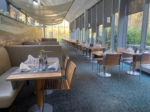 a row of tables and chairs in a restaurant at Castel de Pont-a-Lesse in Dinant